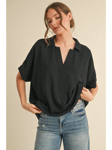 Sold top with open collar and dolman sleeve
